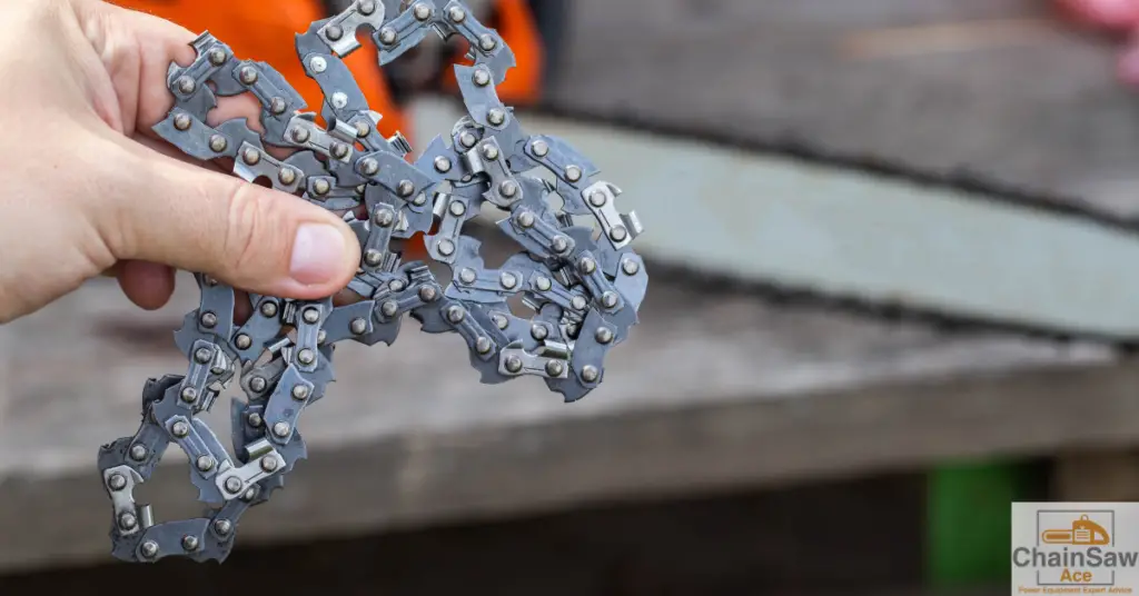 Holding a chainsaw chain by hand.